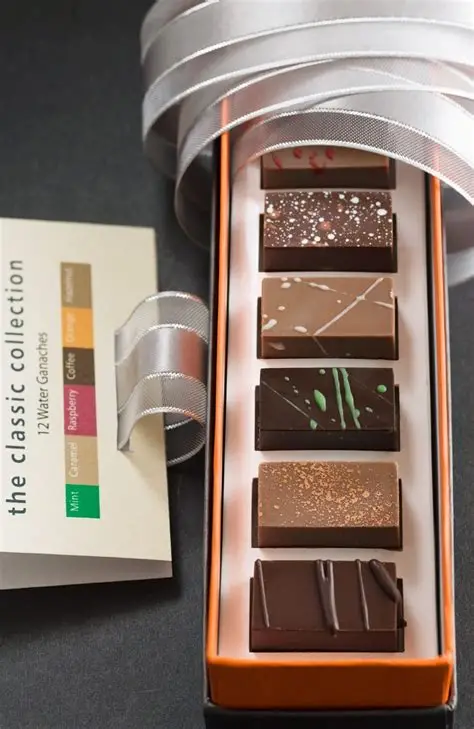 Col·lecció de bombons de xocolata amb diferents sabors i acabats, exemple de bomboneria i tècniques de xocolata professional.